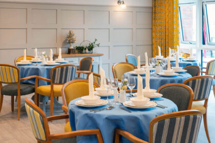 A dining room with blue table cloths