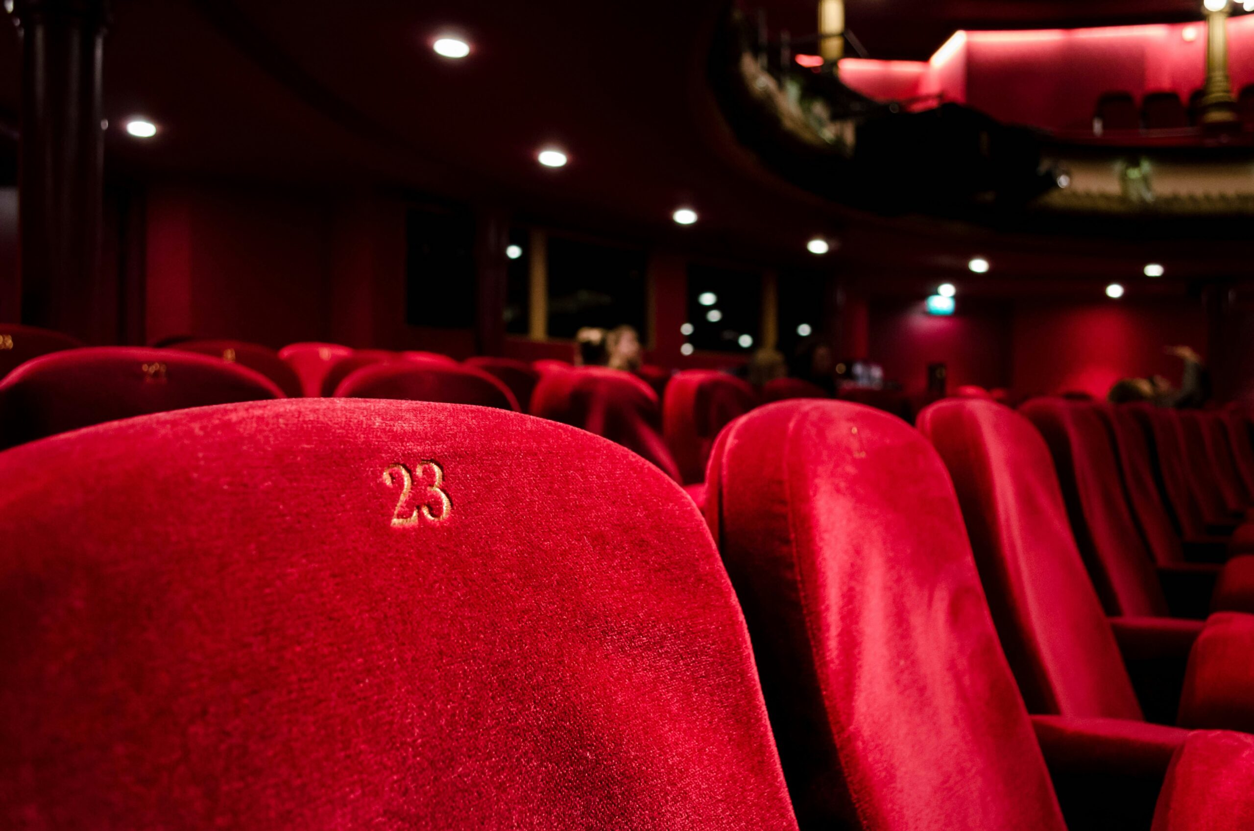 Close-up of plush red theatre seats arranged in rows, West Yorkshire.